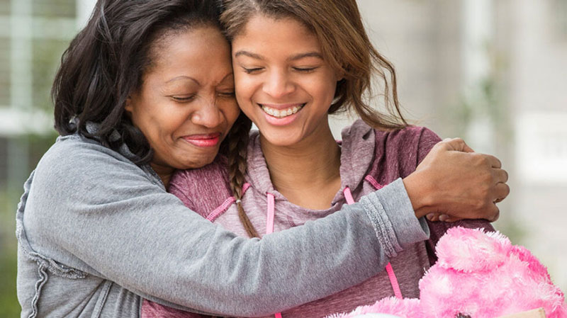 mother hugging daughter